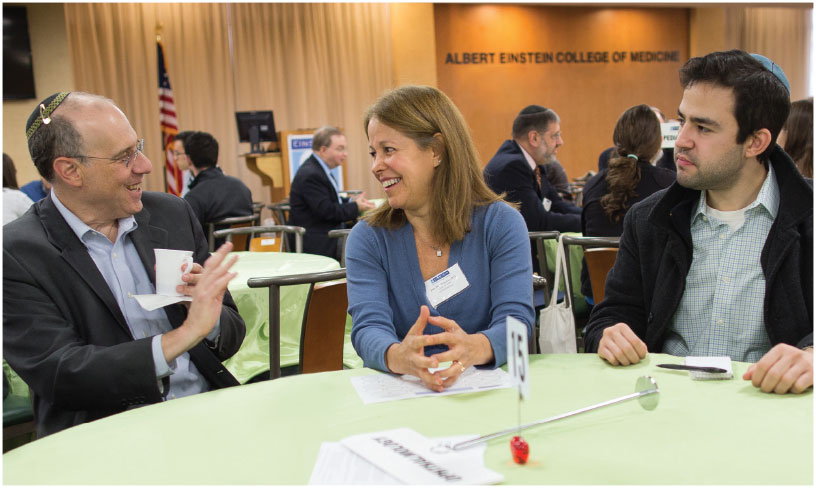 Norman Saffra, M.D. ’88, and Jody Piltz-Seymour, M.D. ’84, members of the Einstein Alumni Association board of governors, with a student, at the Career Speed Networking event held in fall 2015.